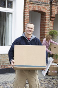 Man and van team loading items safely with protective equipment