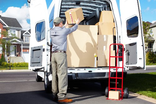 Movers carrying furniture during a fast relocation in Richmond upon Thames