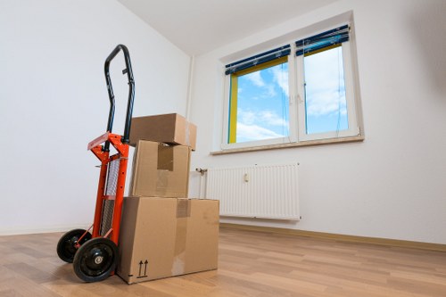 Local movers handling boxes and furniture on a Richmond upon Thames street
